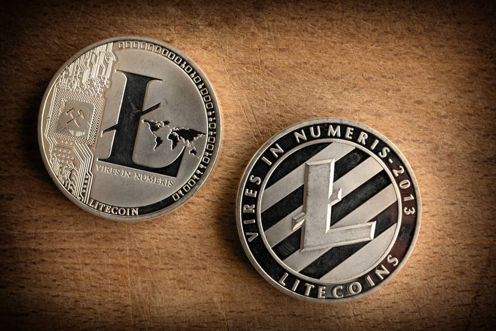 Close up photo shiny silver litecoins laying on wooden background. Isolated litecoin ltc. Detail Macro photo of new modern decentralized cryptocurrency